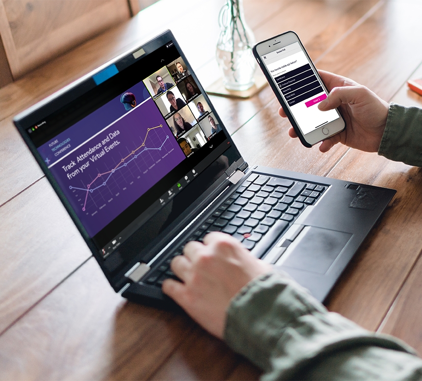 Person using laptop and mobile phone for virtual conference with others on screen, with a graph in view.