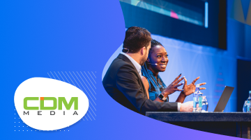 CDM Media logo with a photo of a man and woman talking in front of a laptop.