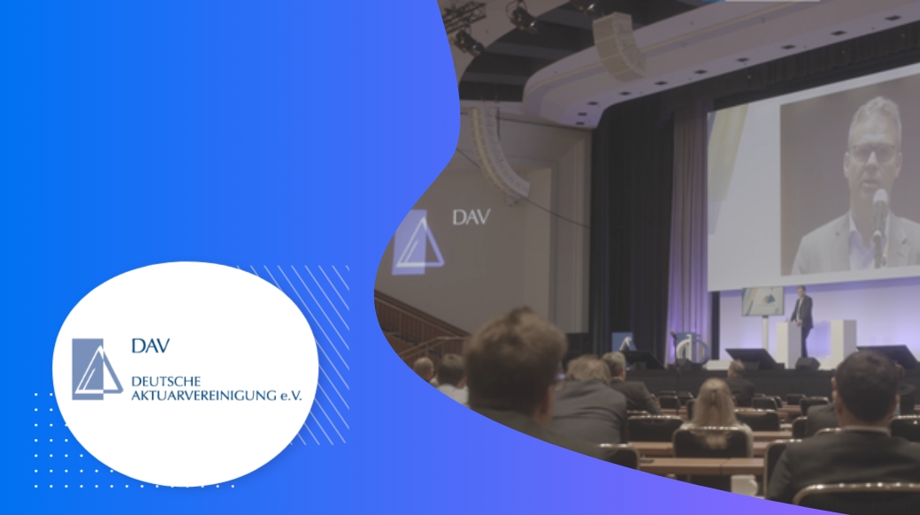 A person on the screen and the audience watching him while the DAV logo is shown.