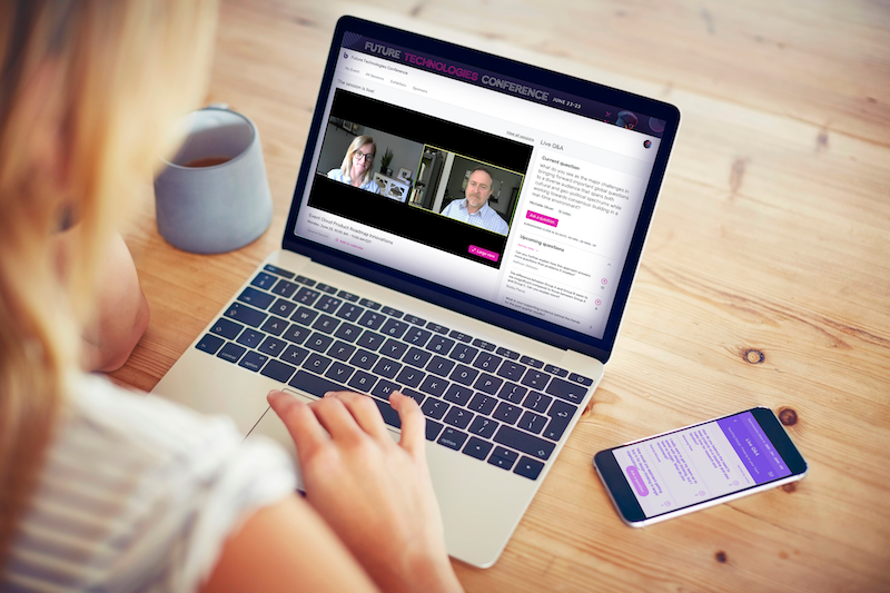 A woman typing on her laptop with a virtual mockup of a conference on her screen.