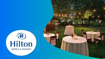 Hilton Hotels & Resorts logo with outdoor event setup, showcasing tables, chairs, and string lights.