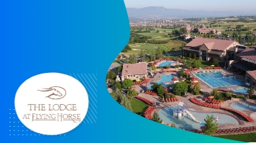 The Lodge at Flying Horse resort with pool, architecture, and lush landscaping in an aerial view.