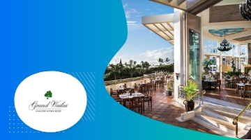 Grand Wailea resort in Hawaii with outdoor dining area and scenic view of landscape and ocean.