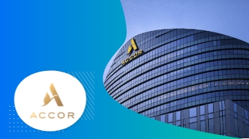 Accor logo and a tall glass building, highlighting its architectural design and branding.