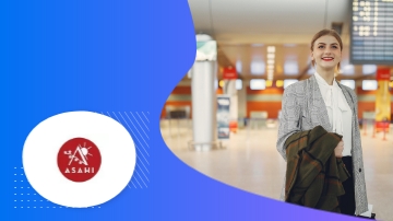 A woman at the airport holding a jacket with an Asahi logo on the left.