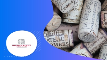 The image shows Deutsch Family Wine & Spirits Total Event Program with wine corks on a blue background.