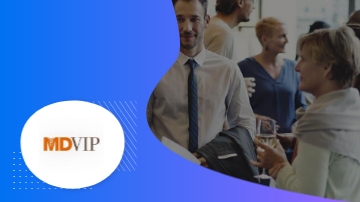 An MDVIP logo with an image of a man and a woman conversing in a social setting.
