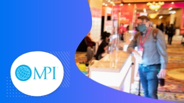 A man wearing a mask stands beside a counter, with the MPI logo on the left side.