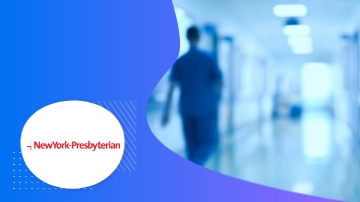 A person in scrubs walks through a hospital corridor in an image from New York Presbyterian.