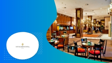 InterContinental Hotel lobby with chairs, tables, and chandeliers, showcasing a luxurious and elegant ambiance.