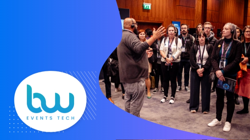 A group of people are standing in a room with a logo of "BW EVENTS TECH"