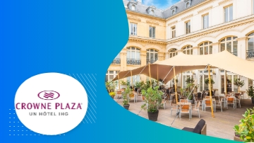 Crowne Plaza hotel with tents, tables, and potted plants, creating a welcoming atmosphere.