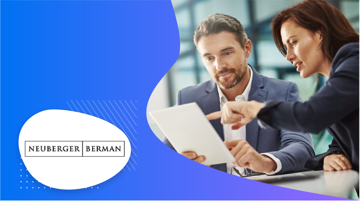 A man and a woman reading a document with Neuberger Berman written in the bottom left corner.