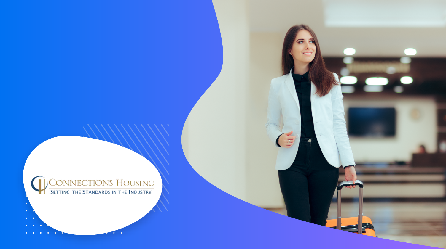A woman with a smiley face, holding a suitcase, and posing for a picture in a hall.