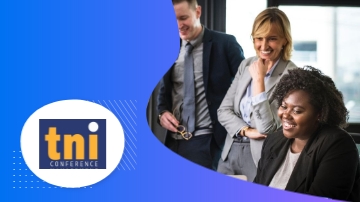 Two men and two women are standing in front of the TNI Conference logo.