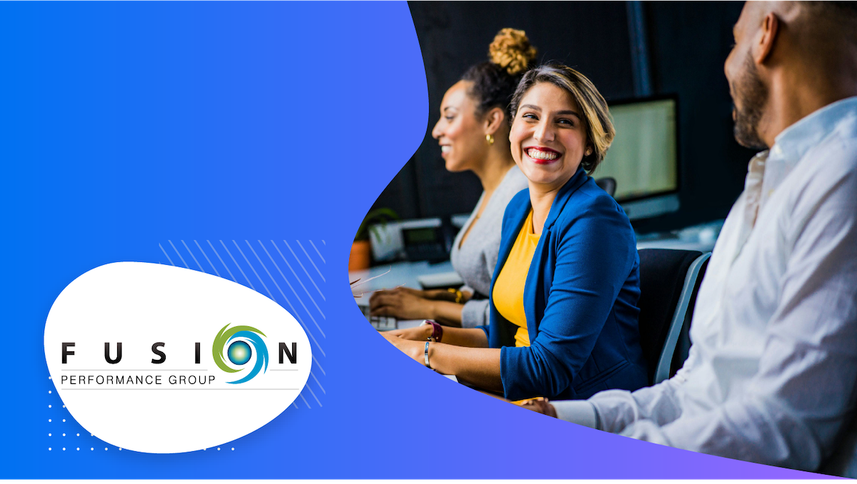 Group of people in office smiling and the Fusion Performance Group logo in the bottom left corner.