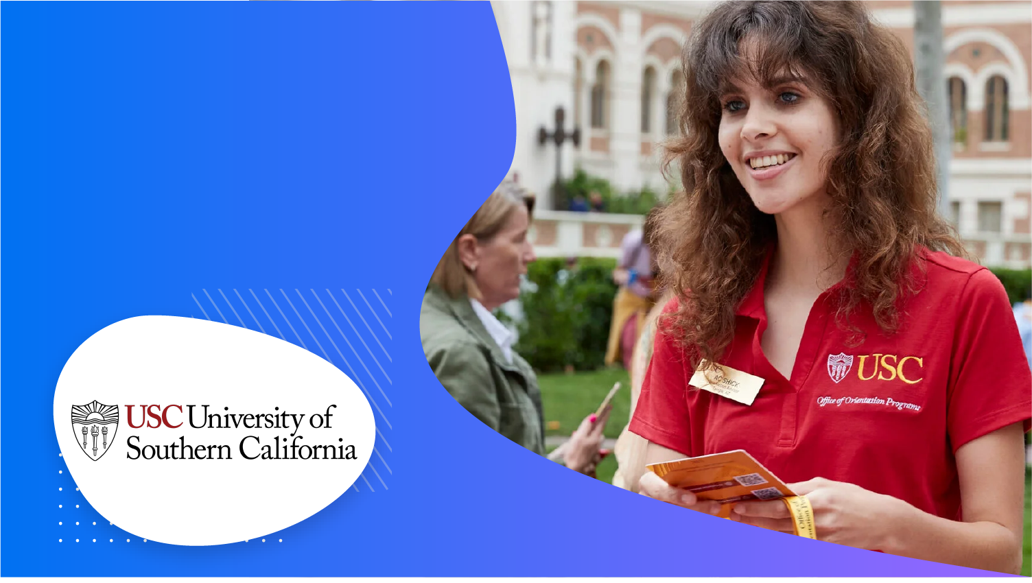 A smiling woman in a red USC shirt holds a pamphlet at a campus event.
