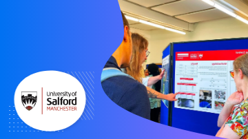 People looking at a poster with the words University of Salford Manchester on a blue background.