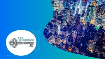 Key Bookings logo over a blue background with an image of city lights in the background.