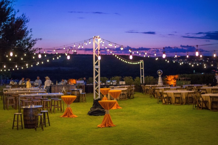 Outdoor reception with mixed seating, lighting, and greenery at Esparza Ranch, evoking a warm and inviting atmosphere.