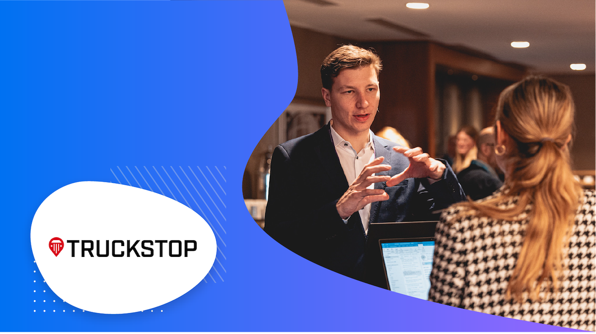 A man is giving a presentation about Truckstop to a woman in an office.