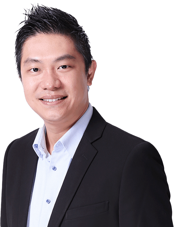 Alvin How, a professional man in a black suit, is smiling for a photo on a black background.