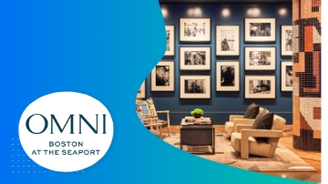 Omni Boston at the Seaport hotel lobby with furniture and picture frames on the wall.