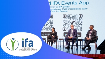 Three people are on stage with QR code and IFA Events App text on the screen.