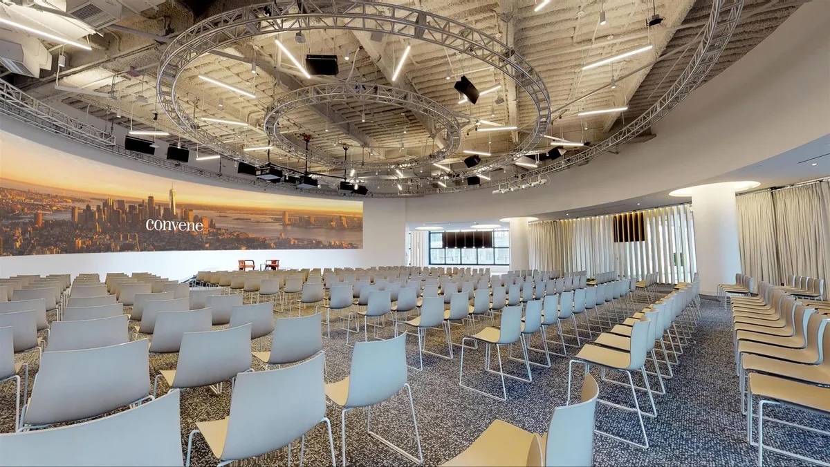 large room with while chairs in rows
