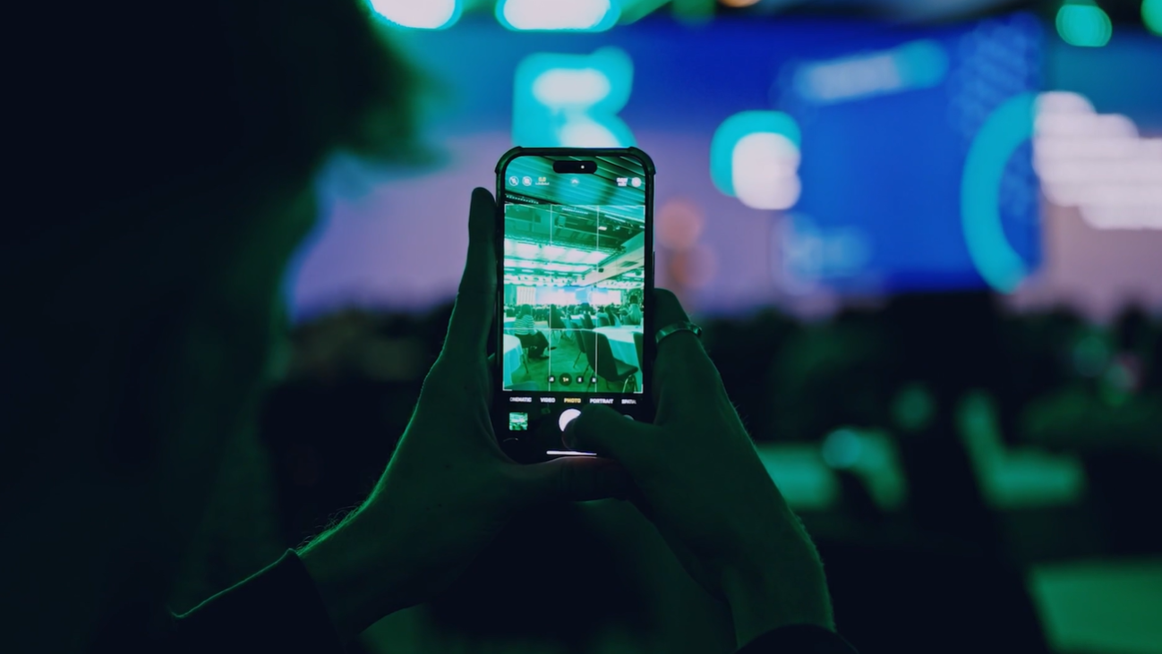 person capturing event with phone