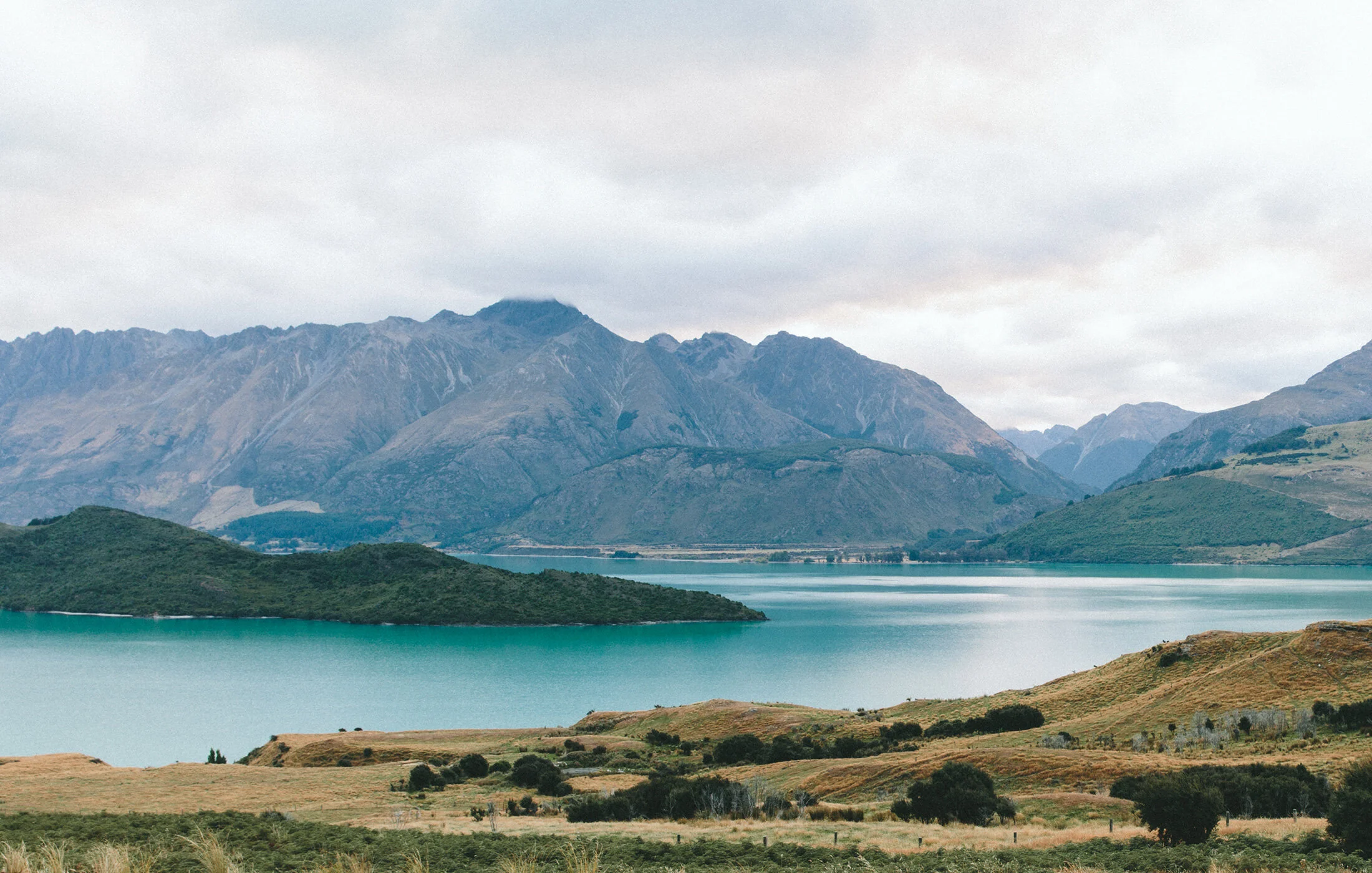 Beautiful scenic image with mountains and water body