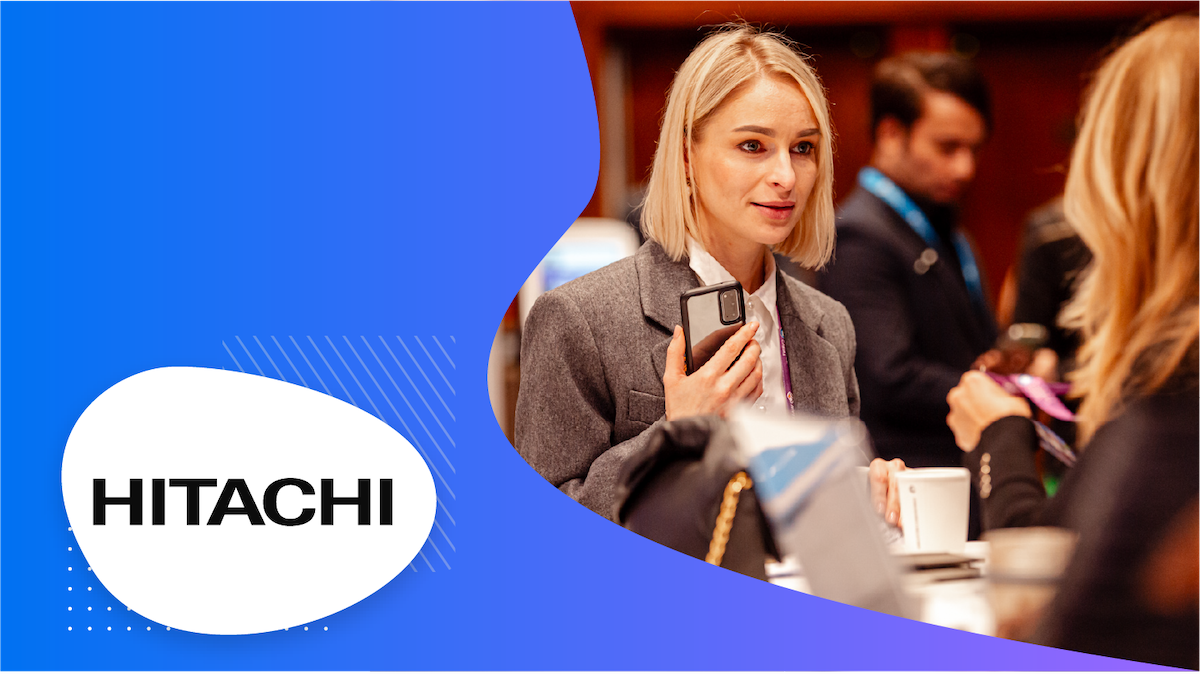 Blonde woman at trade show talking with vendor