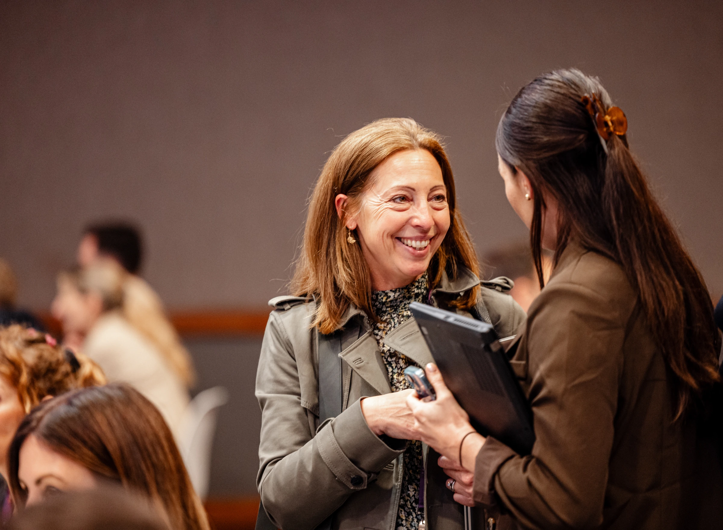 Two attendee greeting each other