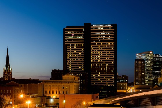 Renaissance Nashville Hotel at night with illuminated windows and a clear blue sky above the city.