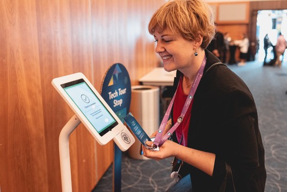 Woman using a tap and go reader at an event