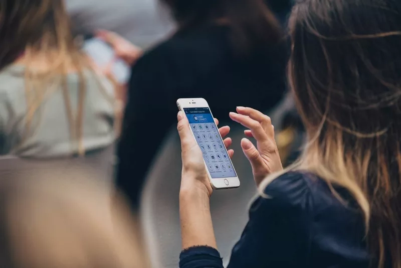 Woman at a conference using an app to give feedback on the sessions she attended.