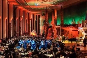Ottawa gala dinner at the Canadian Museum of Civilization in a grand hall with vibrant lighting and columns.