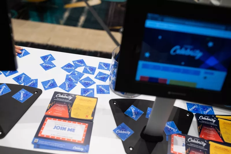 A display of the Cadbury event with cards and a monitor on top of a white table.