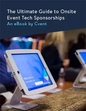 A tablet with a Cvent ebook cover on it, and people sitting at a table.