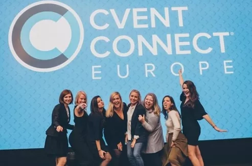 Group of smiling women in front of a blue background with the words "Cvent Connect Europe" written on it.