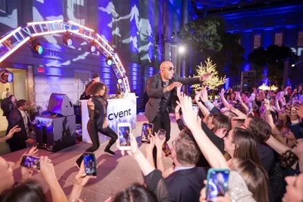 Crowd cheering for Flo Rida during his performance at the 2024 UGA Alumni Holiday Gala.