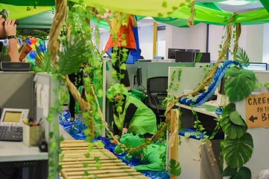 An office with a jungle theme, with a sign saying "CARE ON TH B".