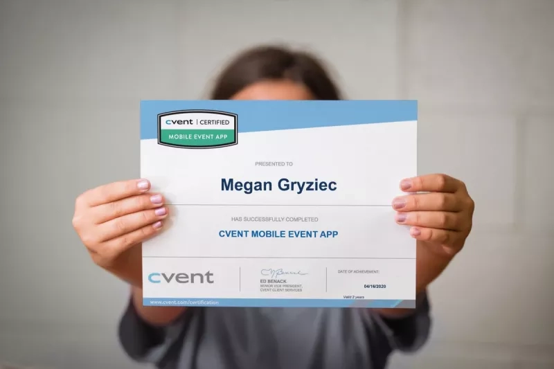 A woman proudly displaying her Cvent certification for the mobile event app.