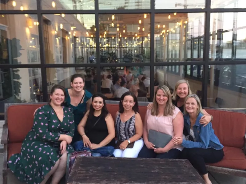 Group of seven women in front of the Glasshouse Restaurant in London, England.