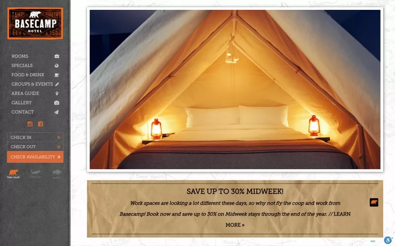 A warm yellow tent with white pillows and lamps on both sides in Tahoe South Basecamp Hotel.