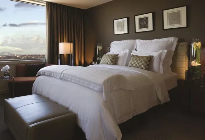 Hotel room with a large bed, large window, and cityscape view, at The Westin Sydney.
