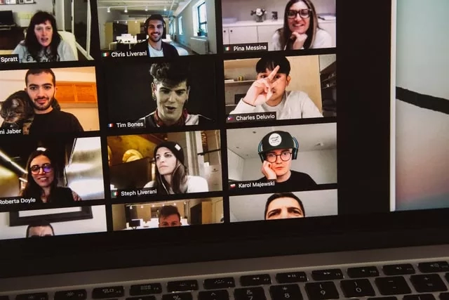 Screen shot of a Zoom meeting with ten students in different rooms, with one cat in the frame.