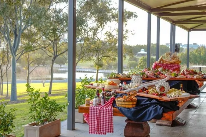 The outdoor dining area of the Waterview restaurant, showcasing a dining table filled with food and a scenic view.