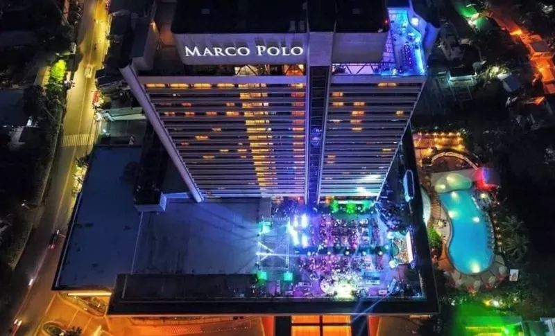 Aerial view of Marco Polo Cebu Hotel showcasing its architecture, landscaping, and ambiance with colorful lights.