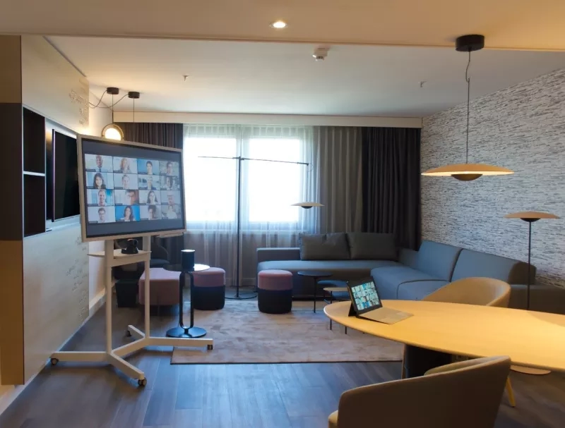 Living room with a sofa, desk, and TV monitor in Park Hyatt Saigon.